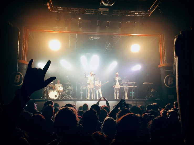 a group of people on stage at a concert