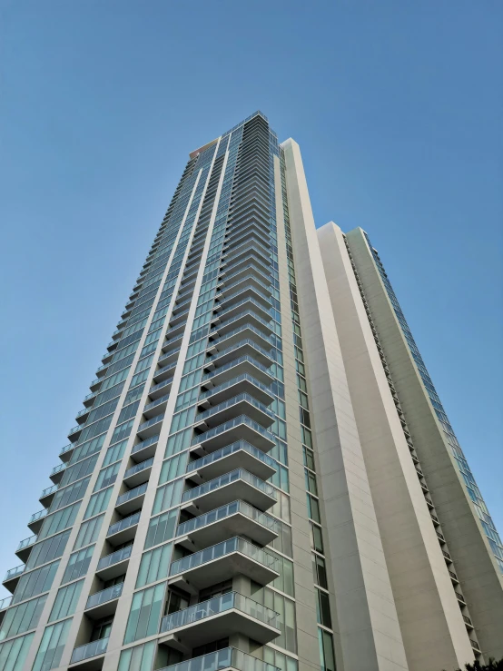 an apartment building with glass balconies on the front