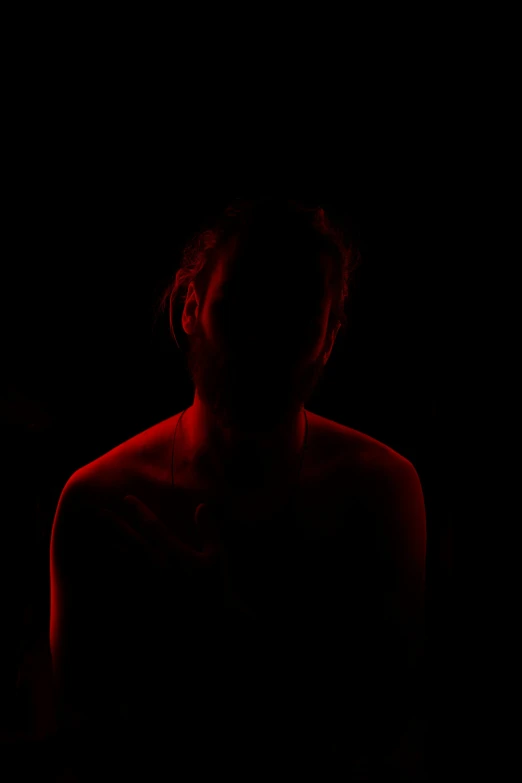 a silhouette of a woman in a red glow