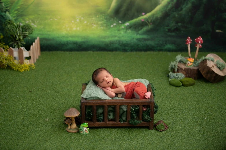 a child laying in a miniature bed and a frog toy
