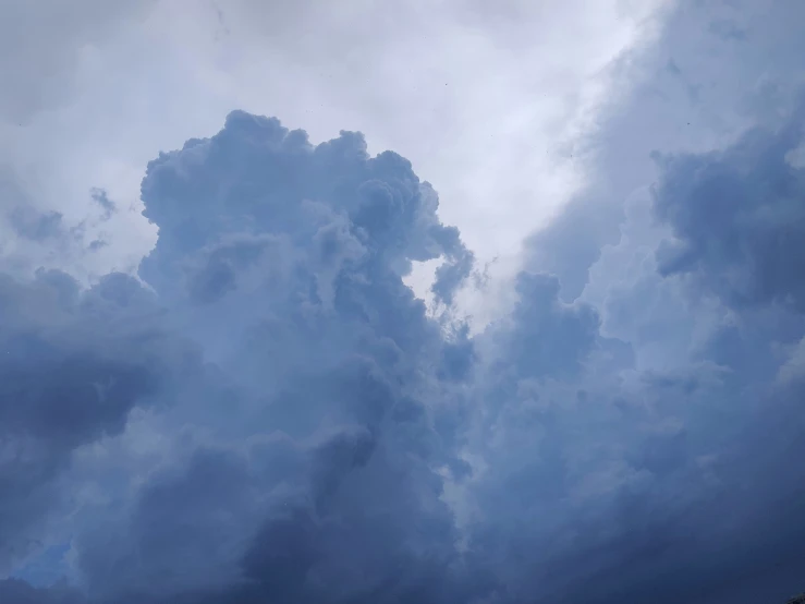 large clouds are seen in the sky over an area