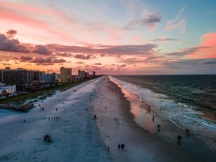 a long stretch of beach lined with tall buildings