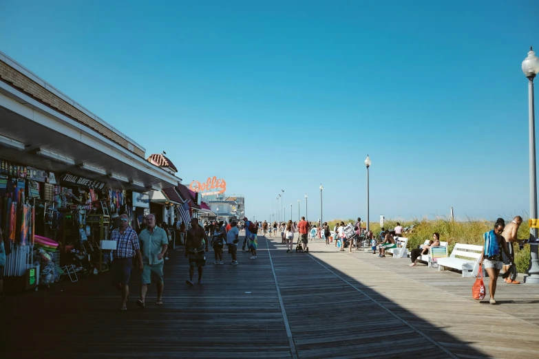 the boardwalk is lined with shops and people shopping