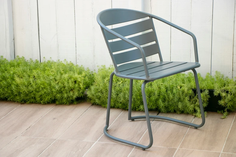 a black chair and some potted plants