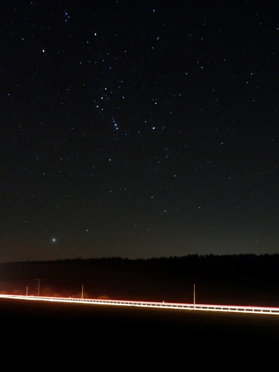 a night view shows the long exposure of lights on the road