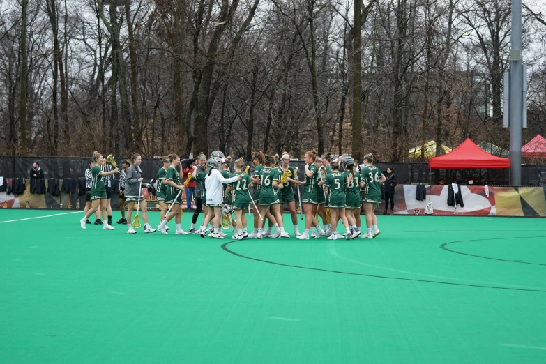 women's lacrosse team huddle together during a timeout