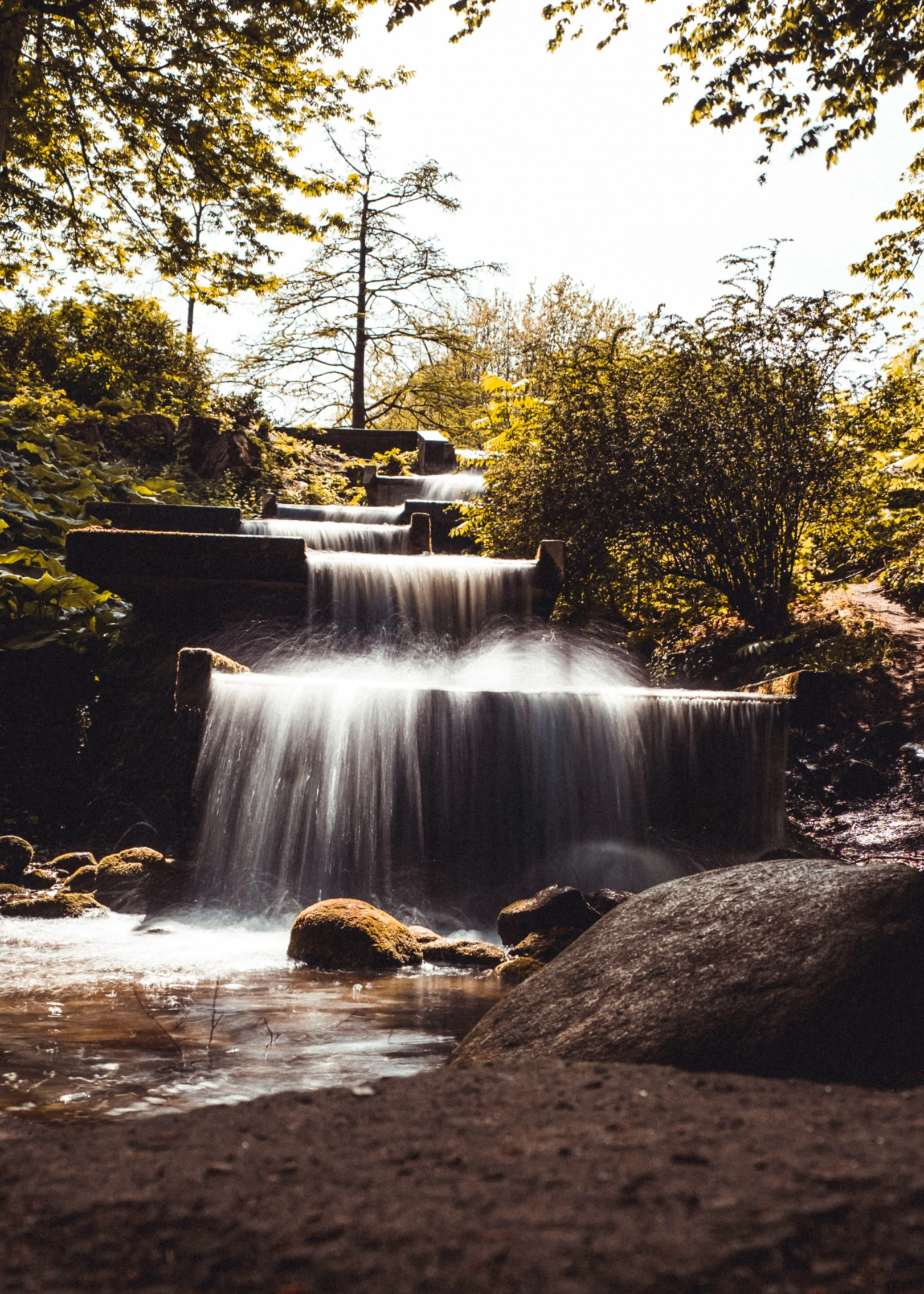 waterfall flowing down from above in the forest