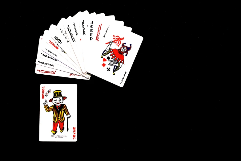 four playing cards are shown in front of the camera