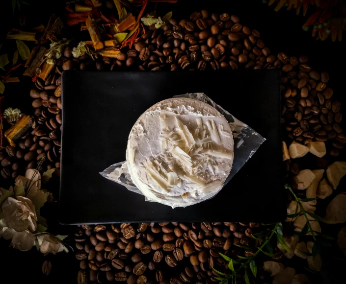 some bread on a table with nuts and a flower