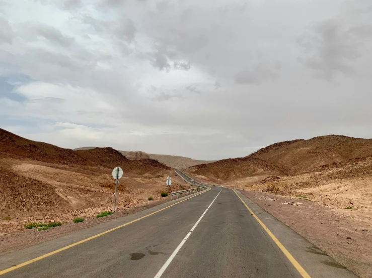 a road leads into a desert plain in the distance