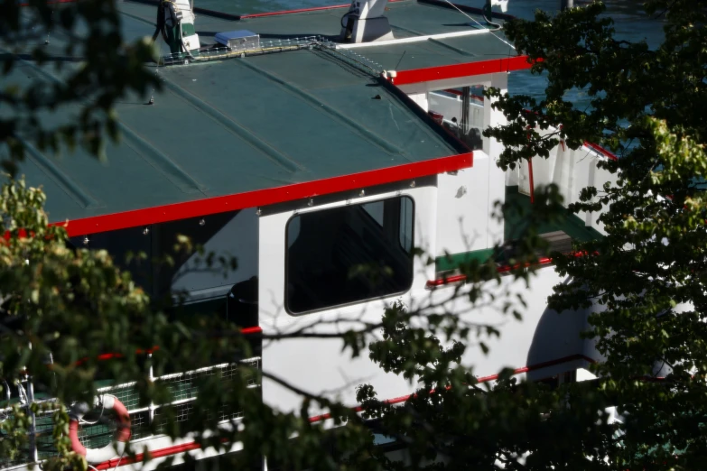 there is a white and red building with a metal roof