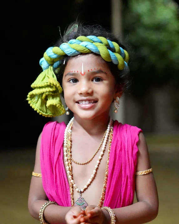  in bright pink dress holding her hand out to palm