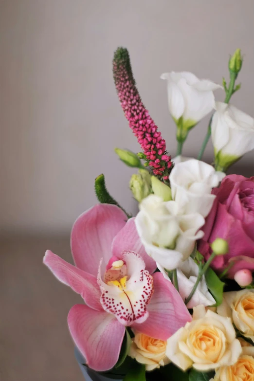 some kind of pink and white floral arrangement on the table