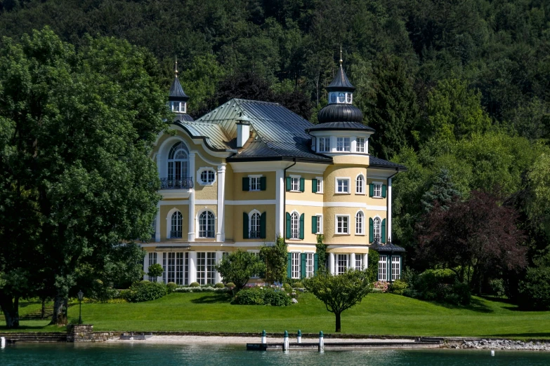 the yellow house is near some trees and grass