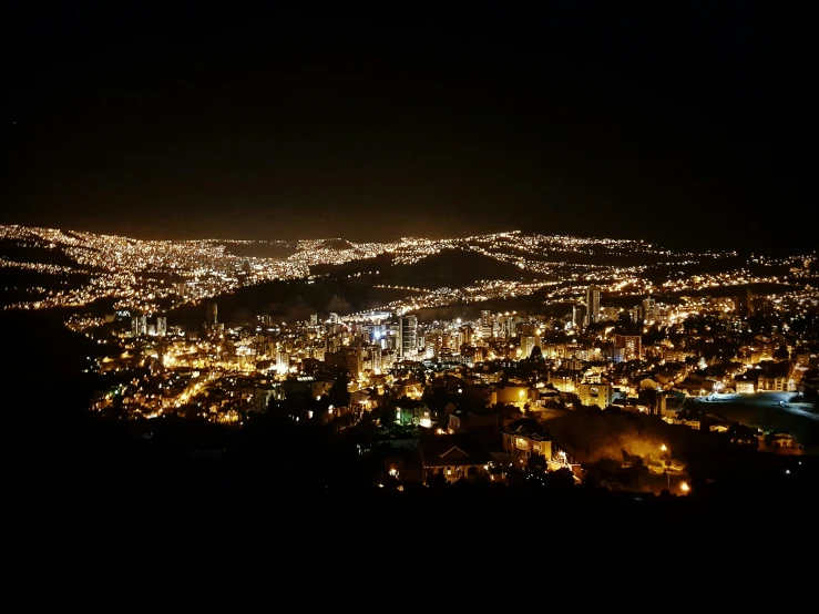 a night scene with lights on buildings in the distance