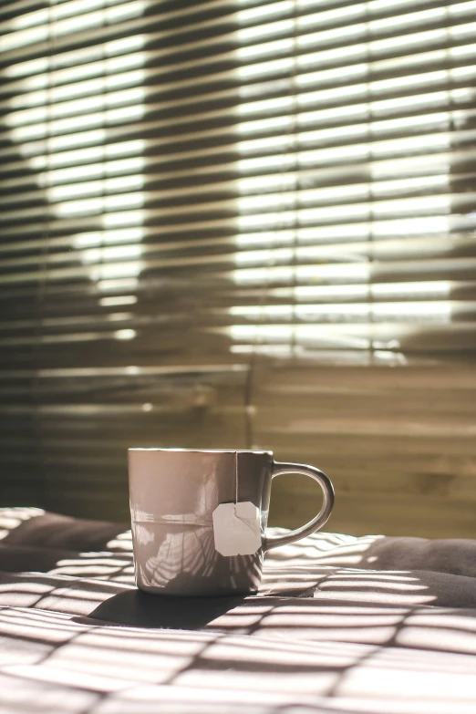 a cup is sitting on top of a wooden table