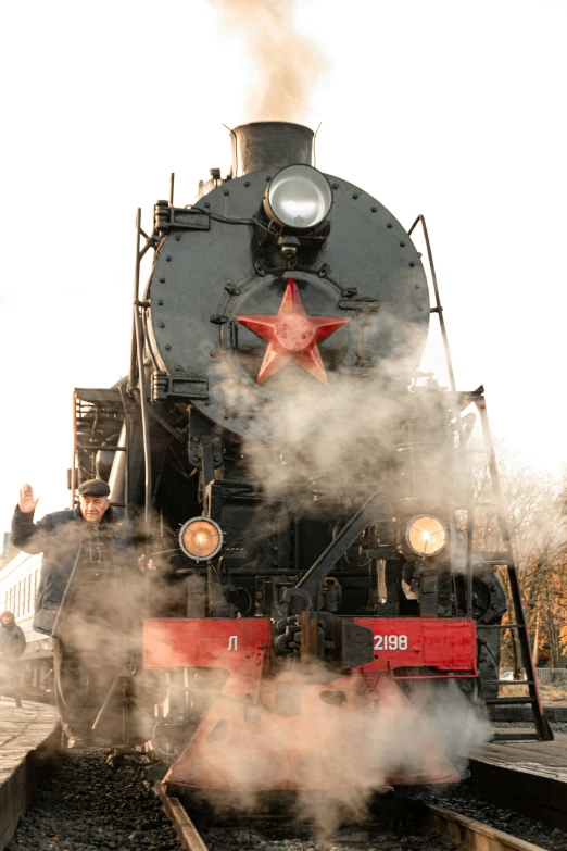 the train has stopped on the tracks near trees