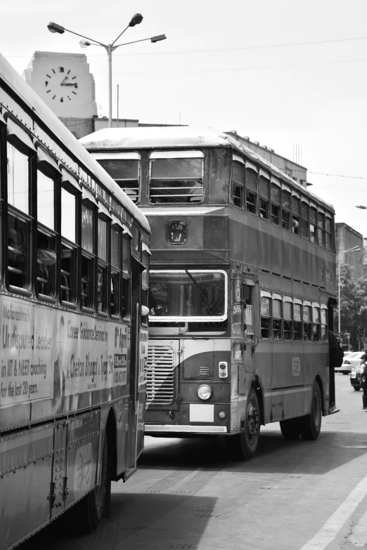 two old school busses sitting next to each other