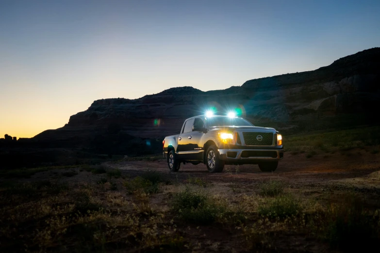 a large white truck sitting in the middle of the desert