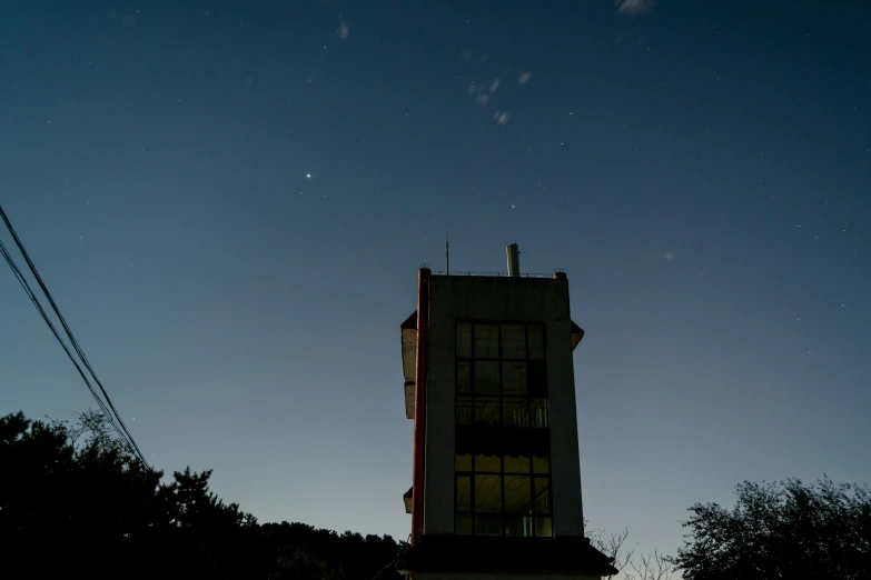 night sky view looking up at buildings with windows