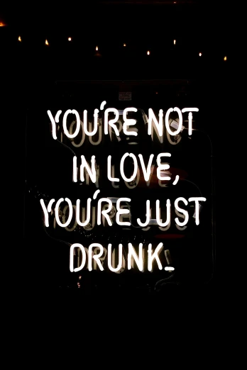a neon sign that says you're not in love