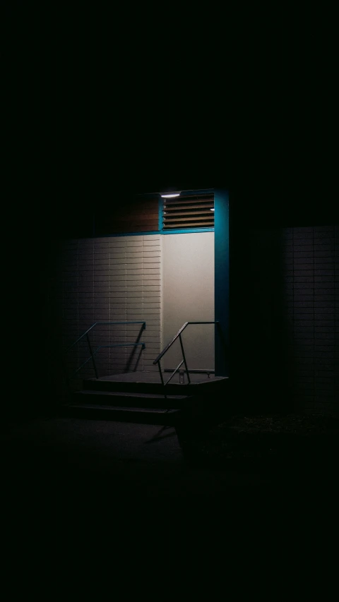 dark pograph of an outdoor wall mounted bicycle rack