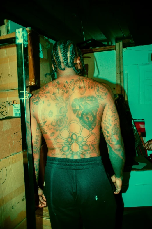 tattooed man with a full back and  on