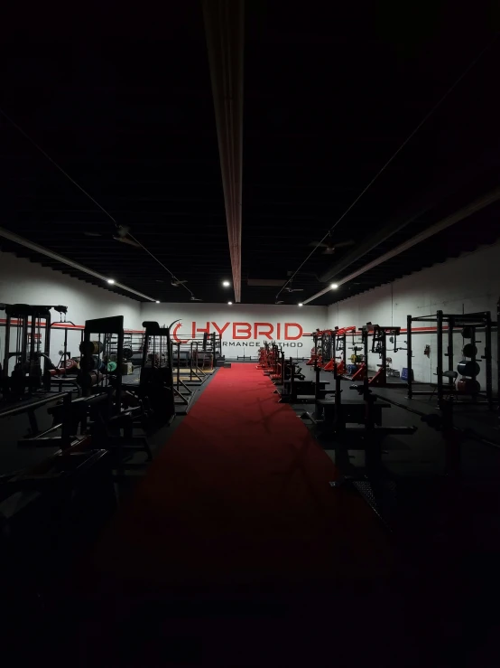 the dark background of a gym with various equipment