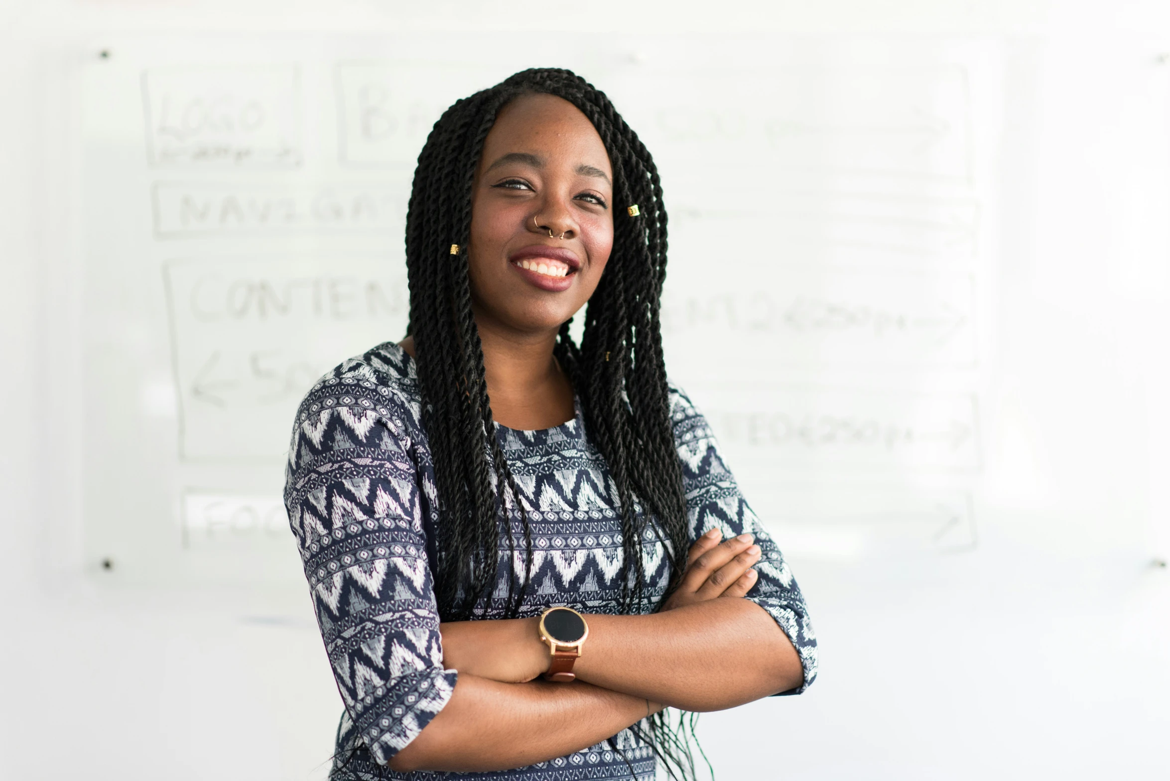 the woman smiles with her arms crossed