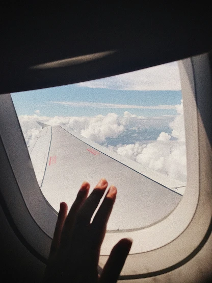 a person is sitting at an airplane window