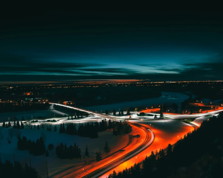 cars driving on a highway at night in the city