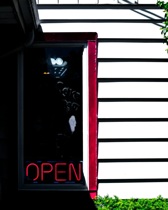 the door of a restaurant with a lighted open sign