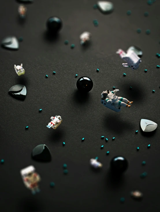 a group of black balls and other items are all scattered across the floor