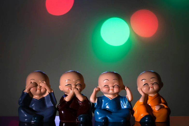 a group of figurines sitting in front of a green and red light