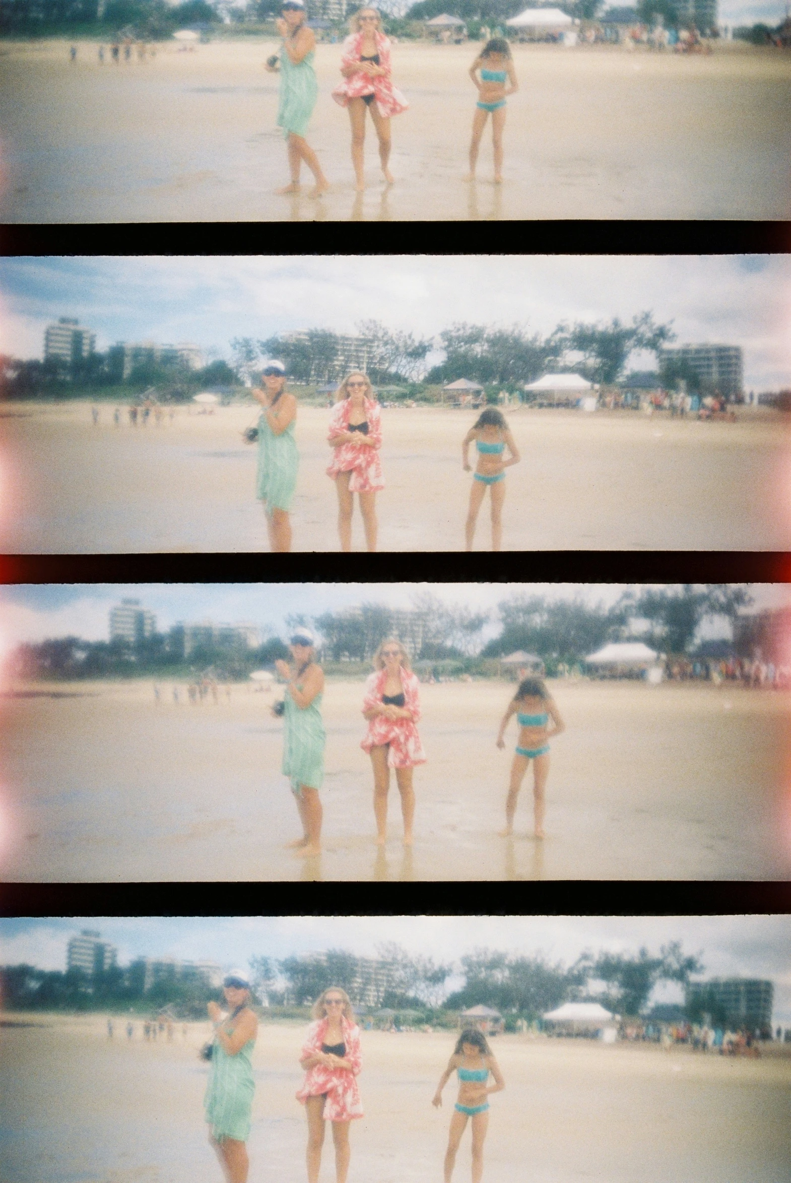 two people in short shorts stand by a body of water on the beach