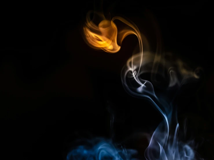 fire and smoke swirl on a black background