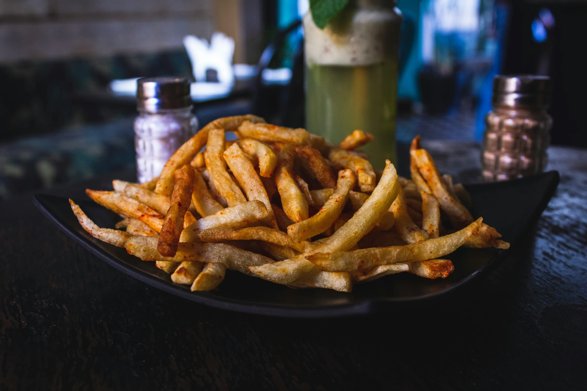 plate of french fries sitting on top of a table