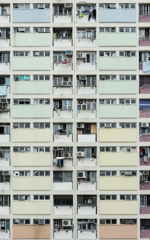 a large multi - colored building has many windows and balconies