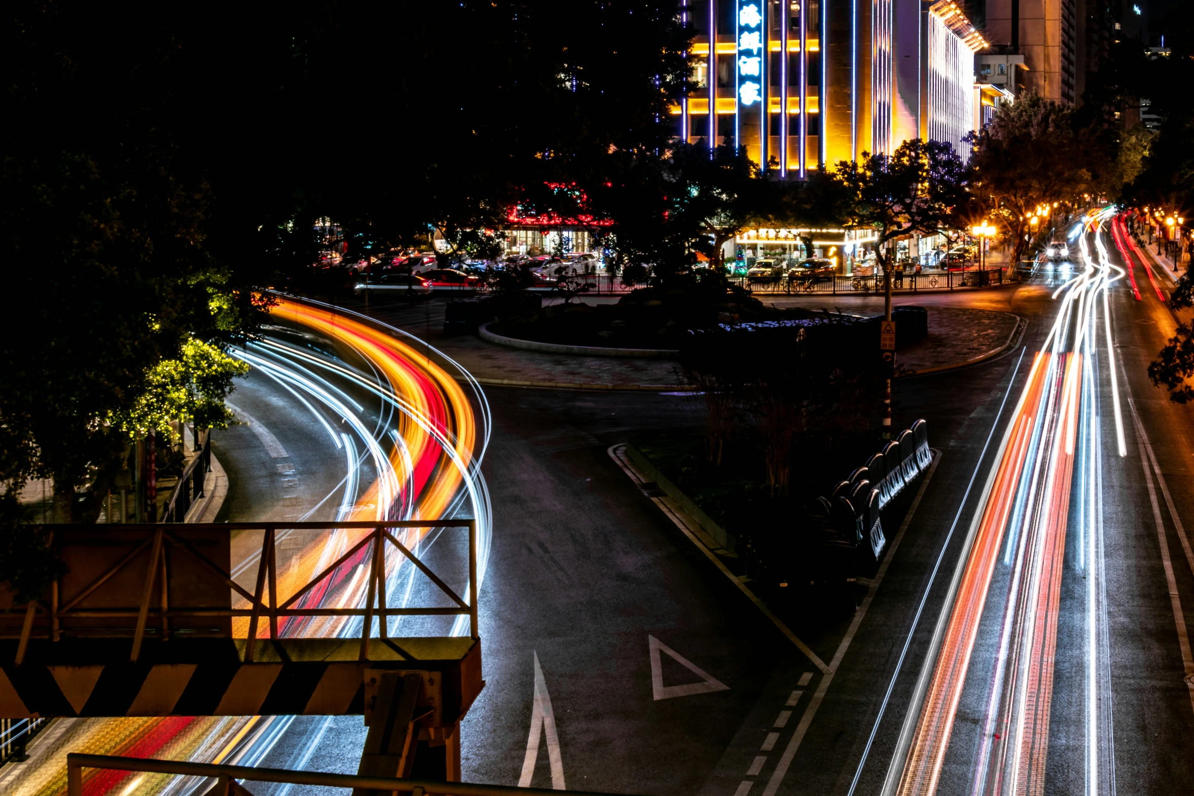 traffic in the night with many different lights on the highway