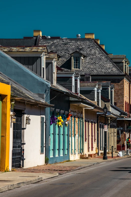 several brightly colored houses line the sidewalk of an old city