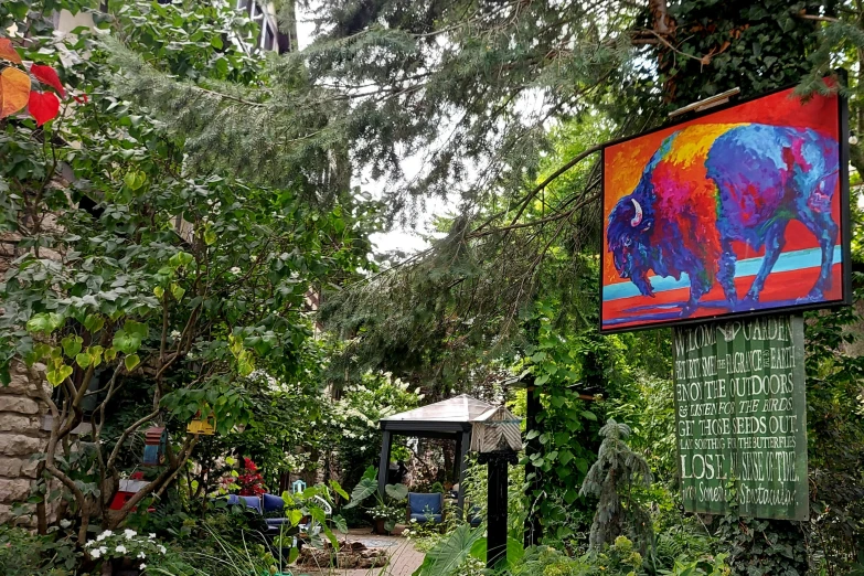 this is an image of some plants and a painting on a wall