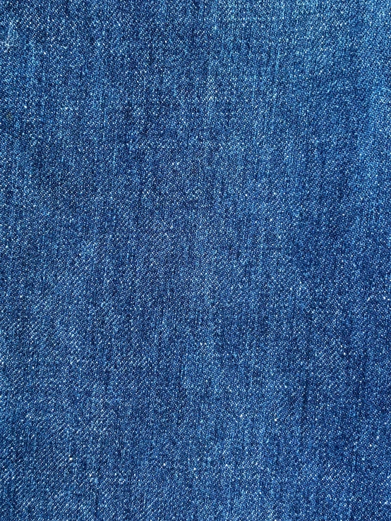 a blue denim background with white embroidery on it
