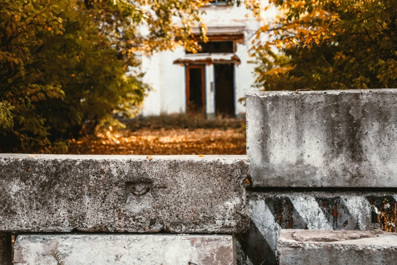 a waterfall sitting between two cement benches and trees