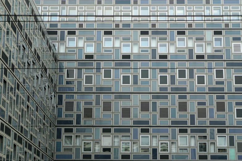 a building with multiple rows of windows next to a street