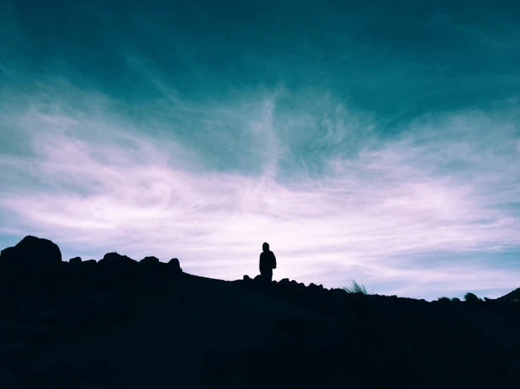 a person standing at the top of a hill