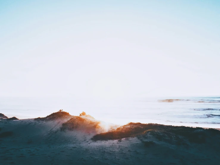 a view from a hill overlooking a body of water