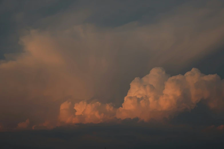 an airplane in the air against an overcast sky