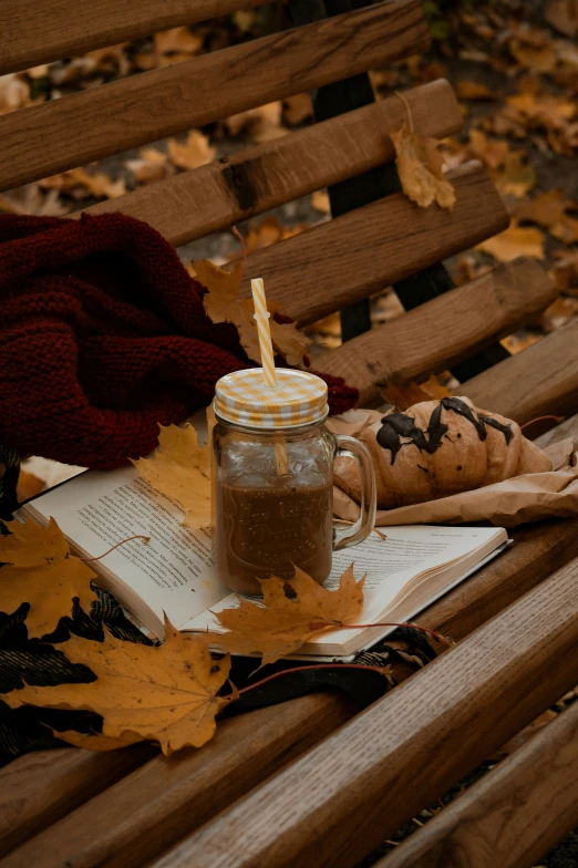 a jar full of coffee sitting on top of a wooden bench