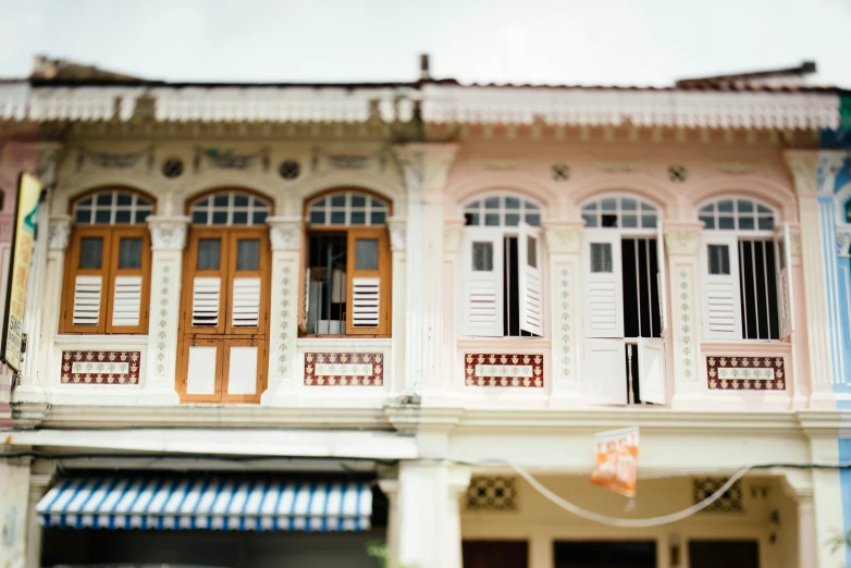 this is an old, colorfully painted building with shutters