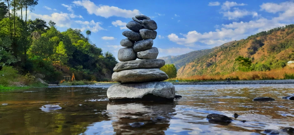 stones on top of each other sitting in water